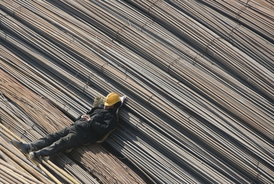 80351-a-labourer-takes-a-nap-on-reinforcement-bars-at-a-construction-site-in.jpg