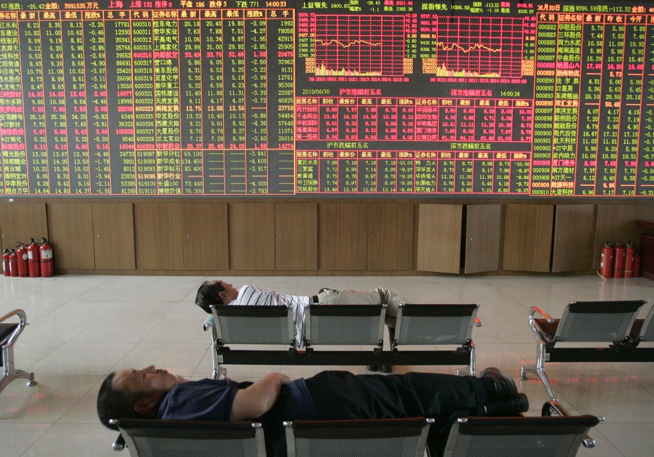 80325-investors-sleep-in-front-of-an-electronic-board-showing-stock-informat.jpg