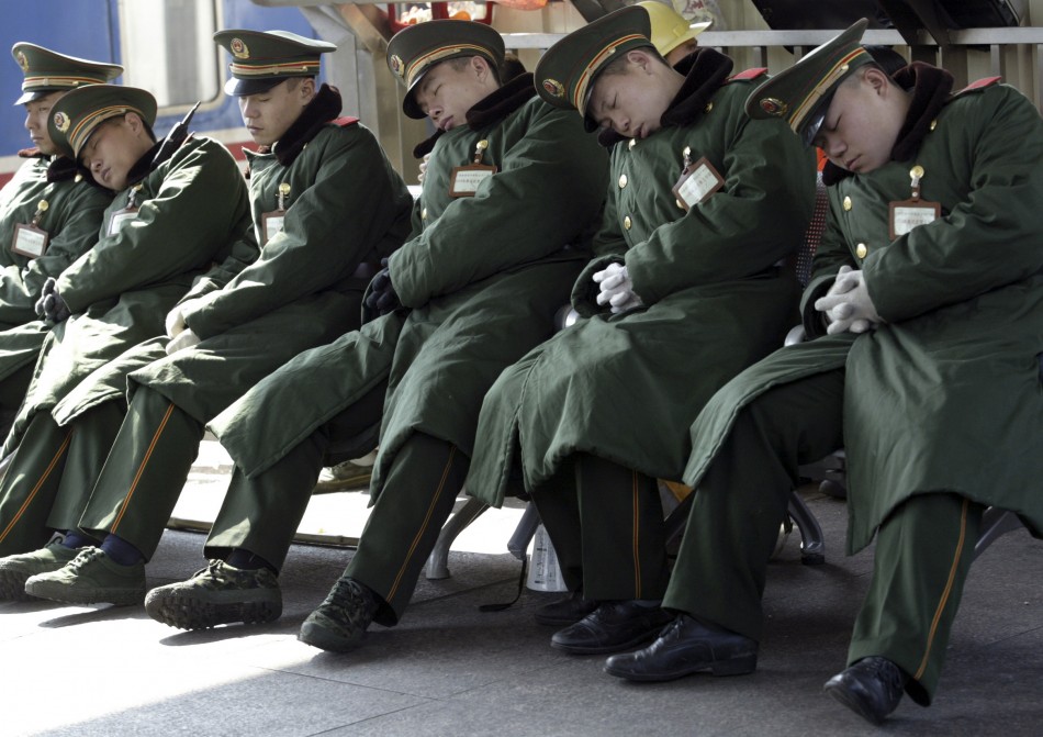80326-paramilitary-policemen-sleep-at-a-platform-of-the-guangzhou-railway-st.jpg